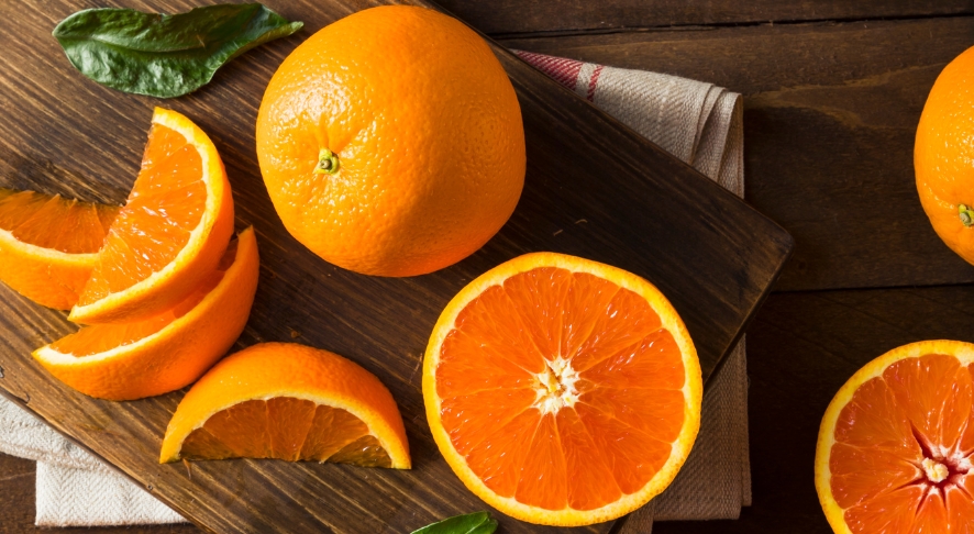 Slices of cara cara navel oranges on wooden board